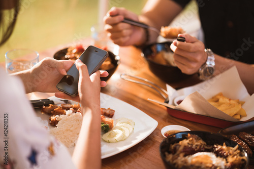 Woman mobile while dining with friends in restaurant