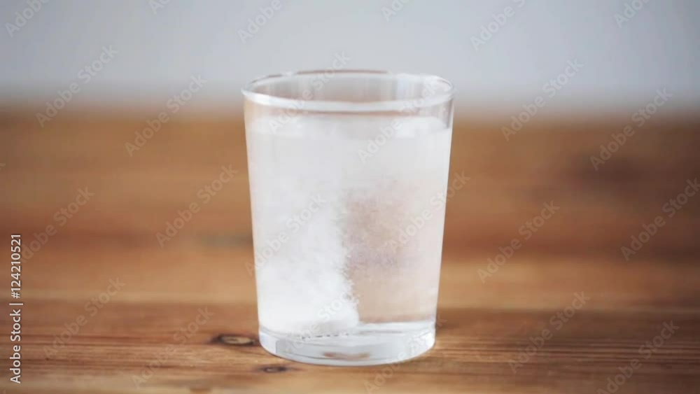 effervescent pill dropping into glass of water effervescent pill dropping into glass of water
