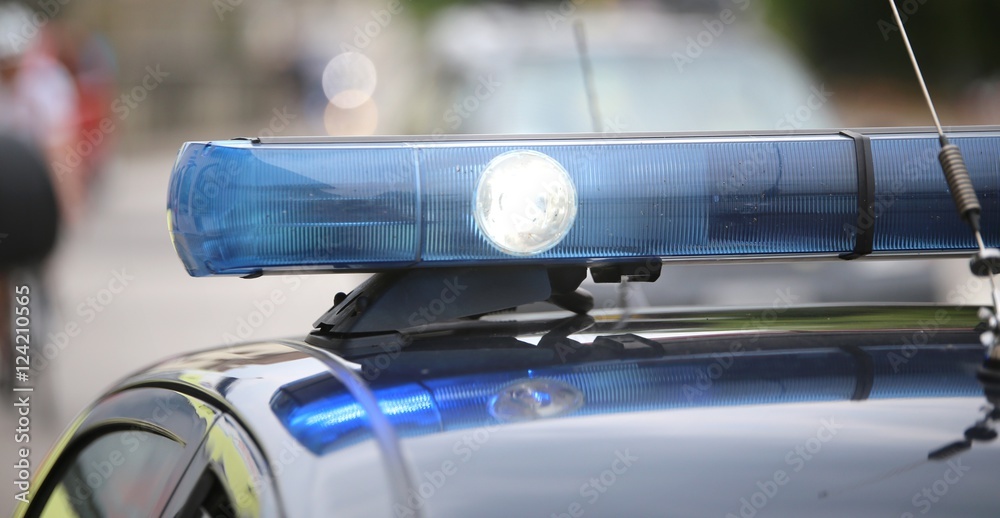 spot light and blue flashing lights of the police car spot light and blue flashing lights of the police car