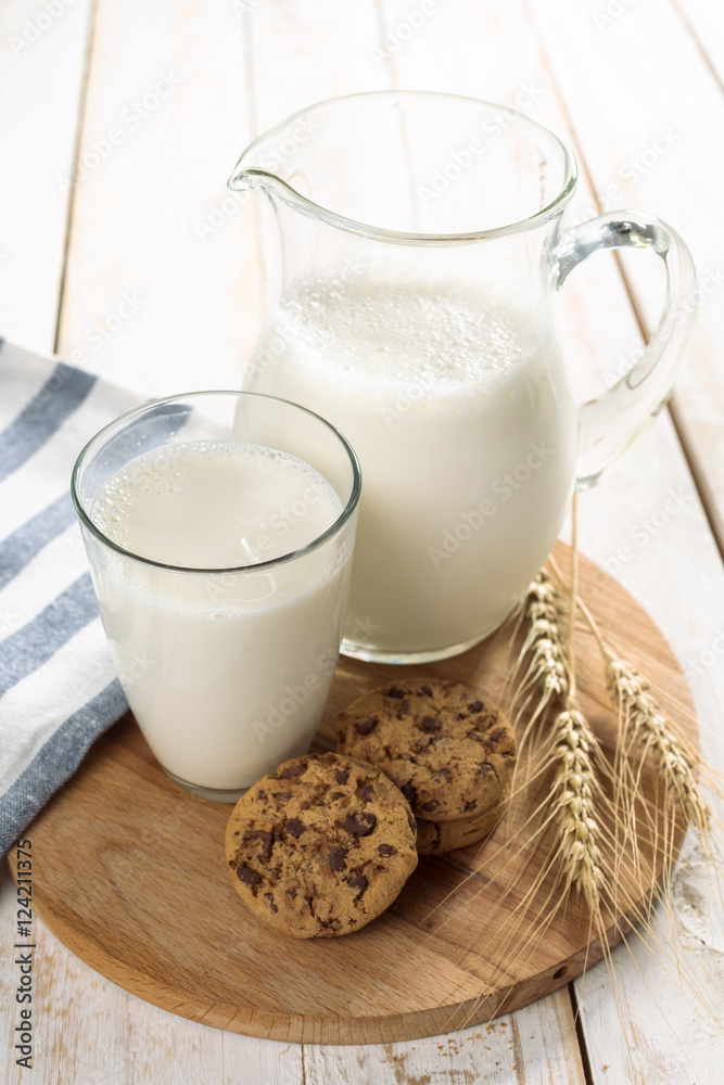 fresh milk in glass jug and glass on wooden background fresh milk in glass jug and glass on wooden background