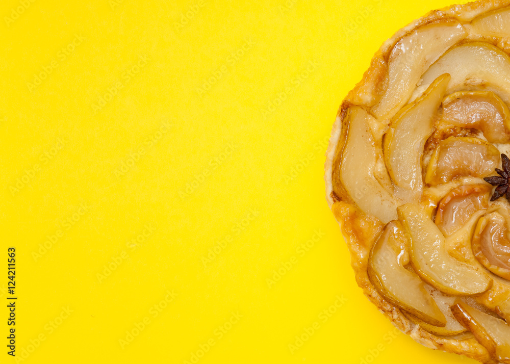 Tarte Tatin apple pear tart isolated on yellow background Tarte Tatin apple pear tart isolated on yellow background