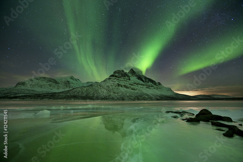 Aurora borealis over a frozen lake in northern Norway