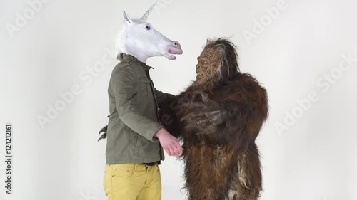 Bigfoot hugging a unicorn man
