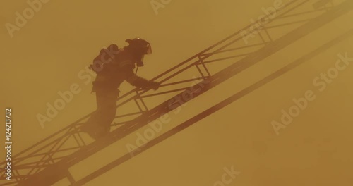 Tracking shot of firefighter climbing up cherry picker