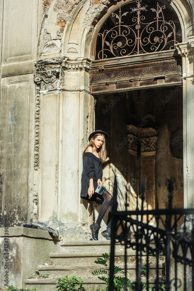 fashionable woman near old building