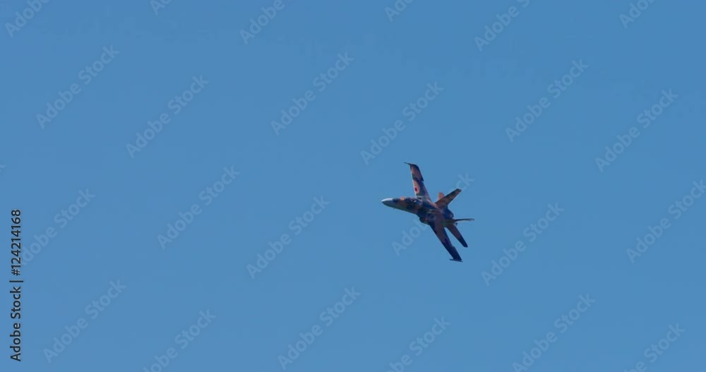 Tracking shot of green camouflage airplane jet flying in blue sky Tracking shot of green camouflage airplane jet flying in blue sky