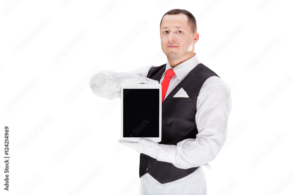 Handsome young waiter in gloves and red cravat holding tablet Handsome young waiter in gloves and red cravat holding tablet