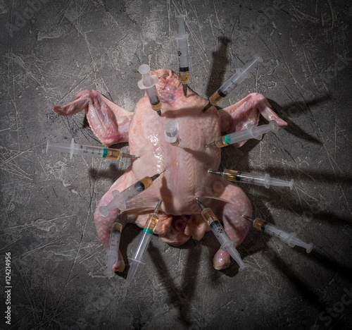 Raw chicken with syringe photo