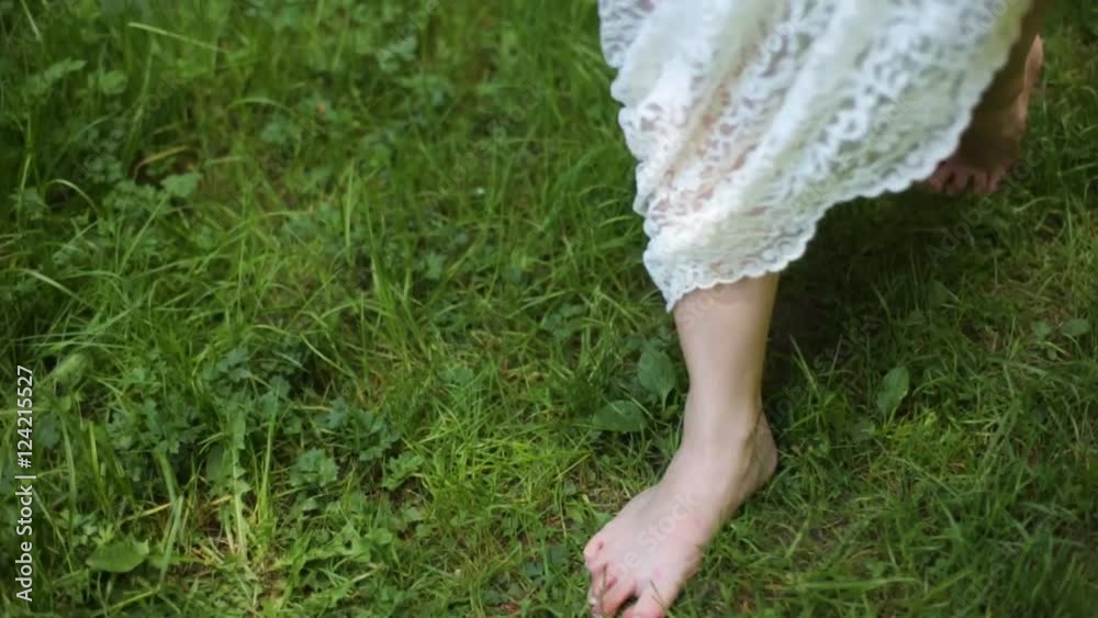 Bride is barefoot on a grass Bride is barefoot on a grass
