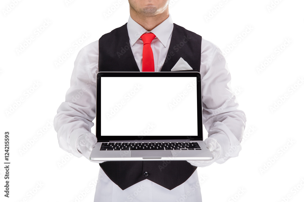 Handsome young waiter in gloves and red cravat holding laptop