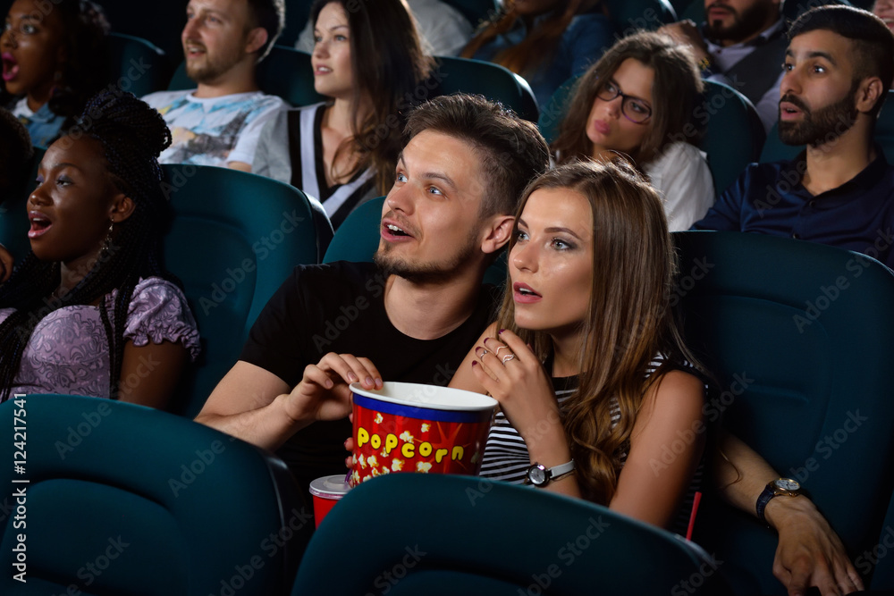 Fototapeta premium Lovely young couple on a date at the cinema