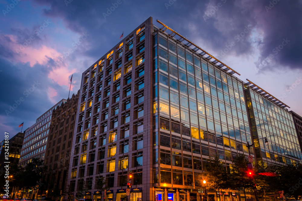A modern building on K Street  at night, in Washington, DC.