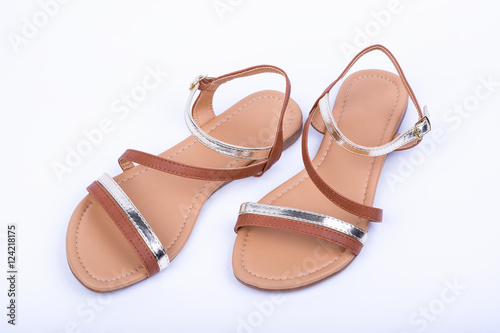 Women's brown sandals on white background. top view photo