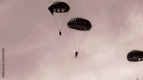 Paratroopers dropping down from the sky photo