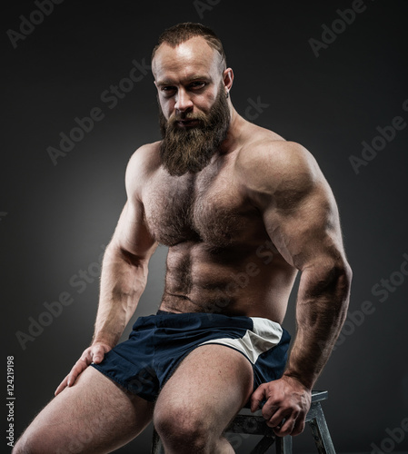 Fotografie Portrait of strong bearded man with perfect abs, pecs shoulders,