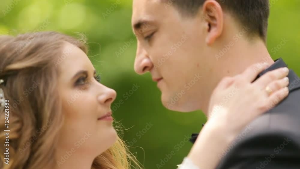 bride and groom embracing on a background of the forest bride and groom embracing on a background of the forest