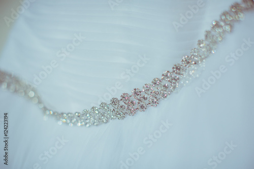 Crystal belt hangs on the wedding dress