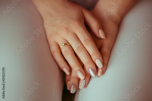 Manicure made in white, beig and silver tones