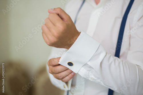 Mans hand wears white shirt and cufflink