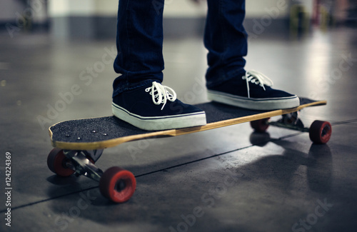 Cropped shot of skateboarder on longboard photo