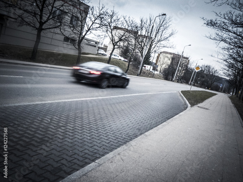 Car passing on Gdansk road on overcast day 