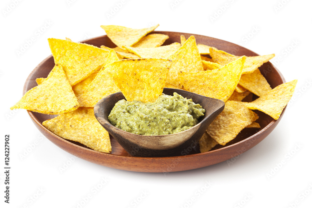 Nachos and Guacamole on wooden plate isolated on white background Nachos and Guacamole on wooden plate isolated on white background