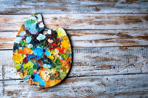 Painting palette on white wooden background