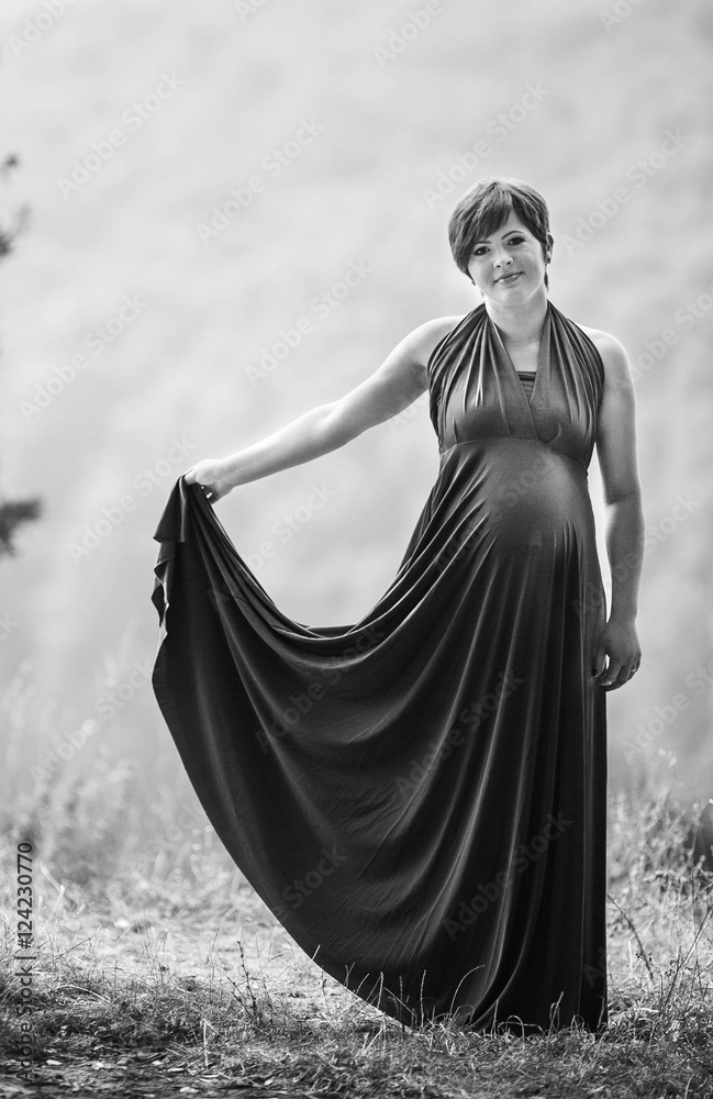 young pregnant woman walks alone young pregnant woman walks alone