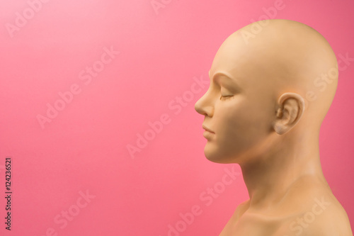 A mannequin against a pink background highlighting cancer awareness