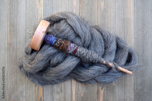 Drop spindle with yarn made of sheep wool photo