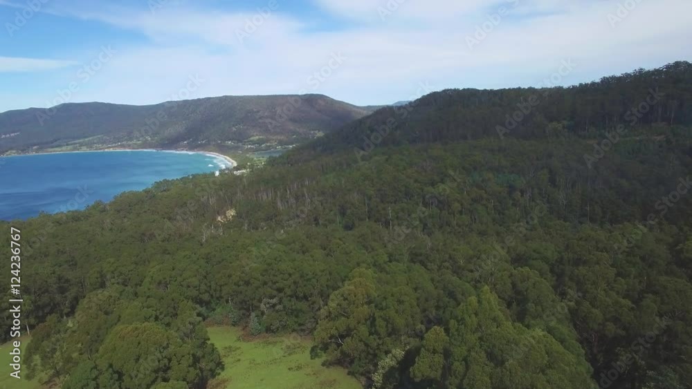 Slow rise over forest revealing The Eaglehawk Neck near Tasman National Park, Tasmania, Australia Slow rise over forest revealing The Eaglehawk Neck near Tasman National Park, Tasmania, Australia