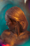Golden light illuminates woman's bronze hair