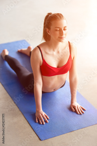 Front view of young woman doing Upward facing dog yoga