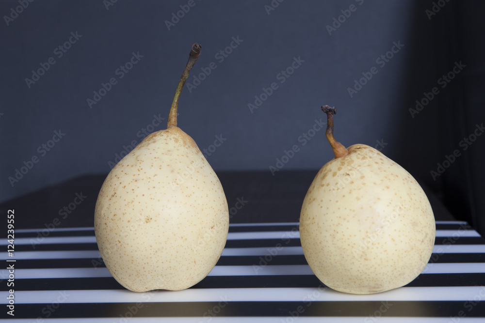 two pears on a black and white striped napkin two pears on a black and white striped napkin