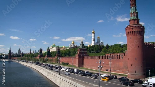 Kremlin Embankment. Vasilevsky Descent. Red Fence, Tower. Road Along the Moskow River. Traffic on the Road. Blue Sky. Summer Season. Wide Shot photo