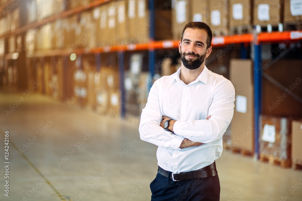 Logistics manager posing in warehouse - obrazy, fototapety, plakaty 