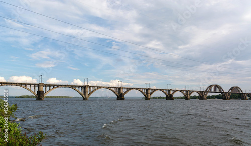 High arched railway bridge made of concrete across the Dnieper River in the city of Dnepropetrovsk. Ukraine  5 June 2016