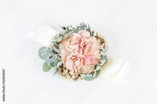 Tela Dusty pink carnation wrist corsage isolated on white background