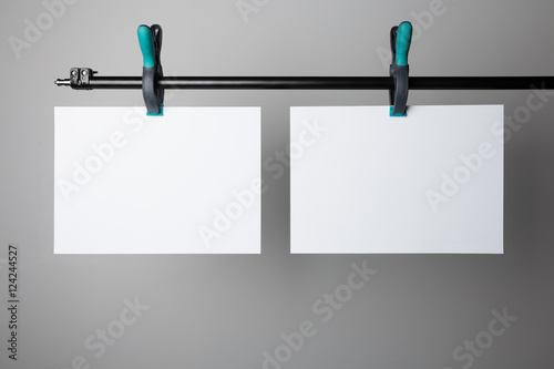 Blank poster hanging on A Clamps