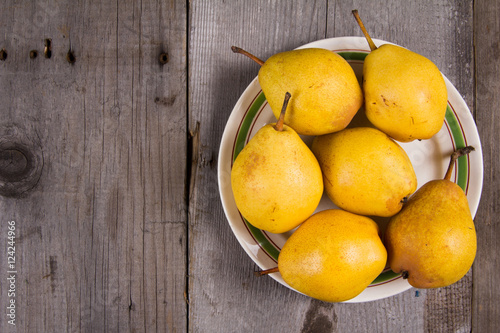 Fresh ripe organic yello pears on rustic wooden table, natural background, diet food.