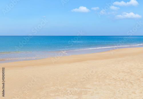 Empty tropical beach and blue sea with blue sky and white cloud background 