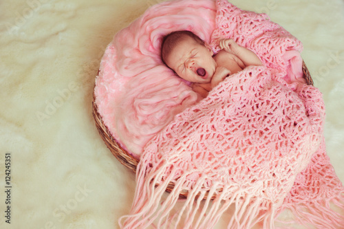 Cute sleeping newborn baby in the basket