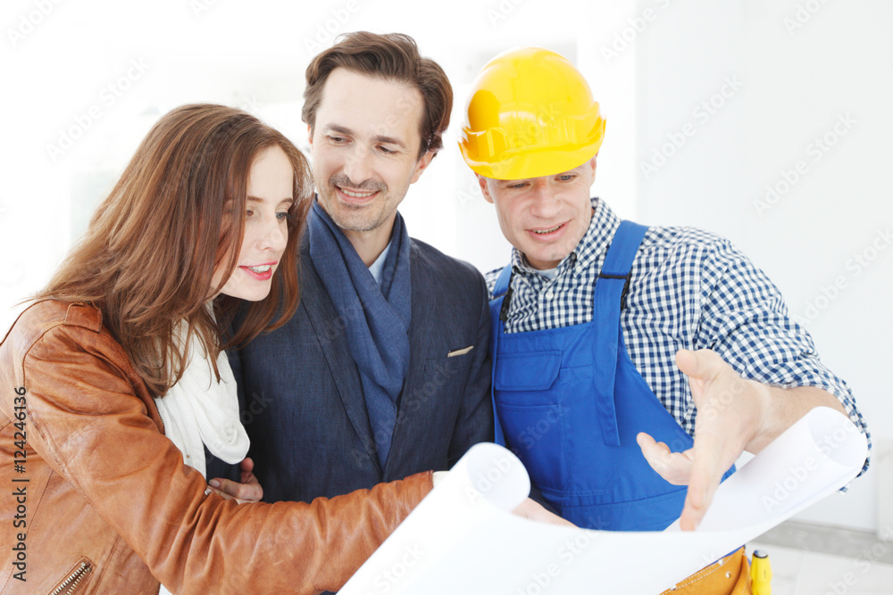 Worker shows house design plans Worker shows house design plans