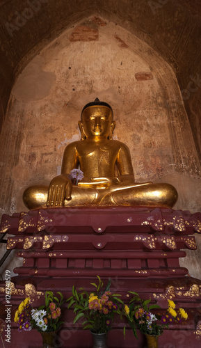 Ancient architecture of old Buddhist Temples at Bagan Kingdom  Myanmar  Burma . Golden Buddha statue inside one of pagoda ruins