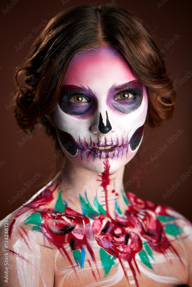 attractive young woman with sugar skull makeup
