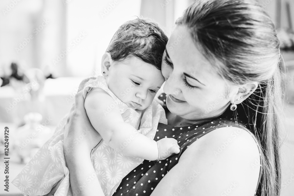 Fototapeta premium young beautiful woman holds her child