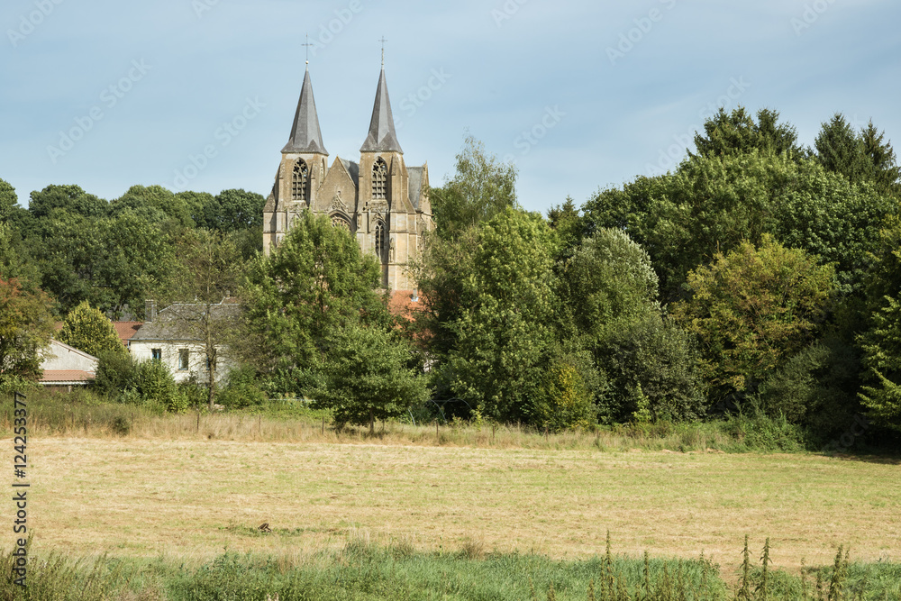 The field Basilica. Our Lady of Avioth seen from the fields, surrounded by a pastoral landscape