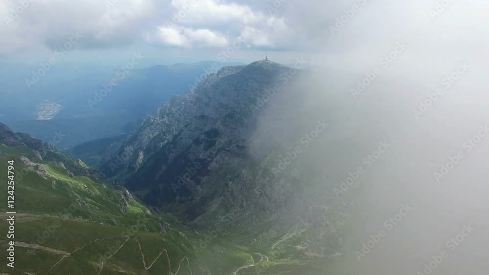 Bucegi mountains, Romania, aerial flight into first layer of clouds