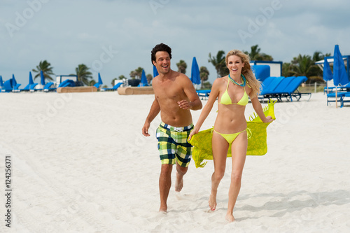 Young Couple Man and Woman Playing Running on Beach © Eric Hood