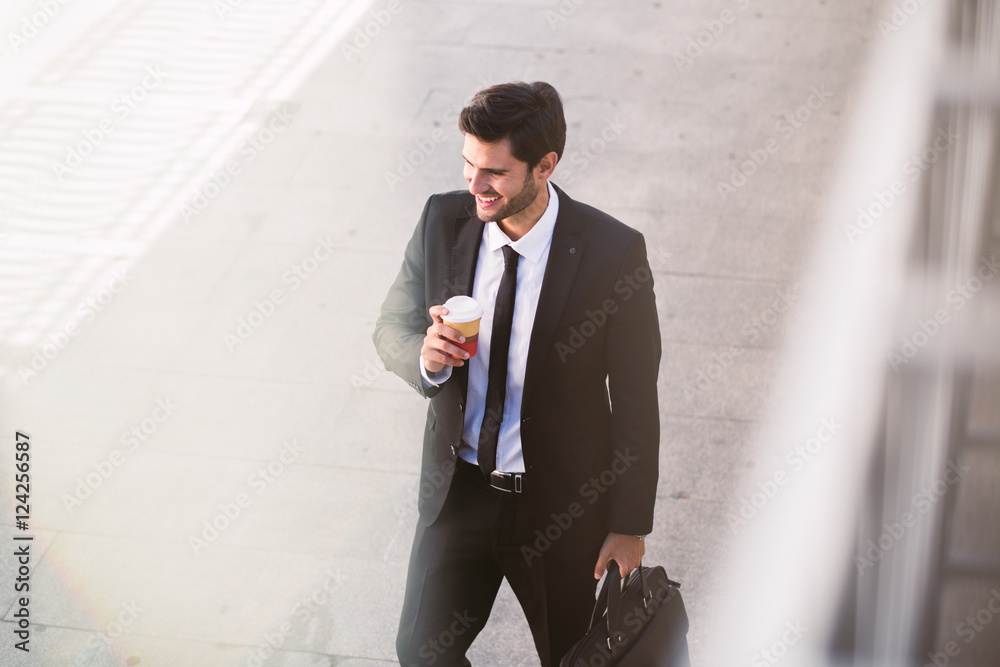 Stylish businessman with coffee to go in the street Stylish businessman with coffee to go in the street